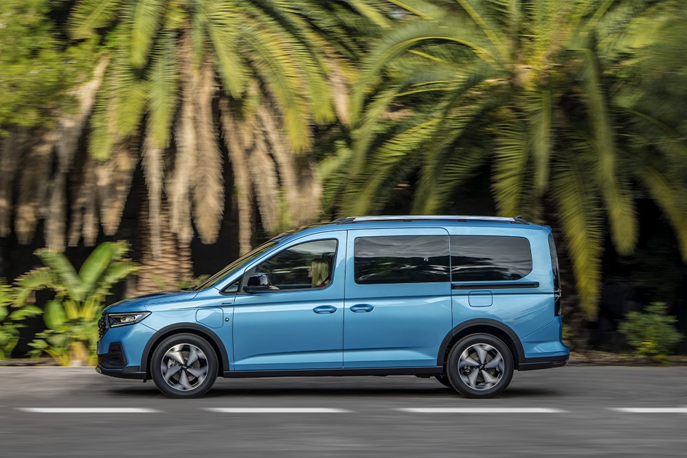 O furgonetă Ford Tourneo Connect hibridă de culoare albastră, parcata pe o stradă.